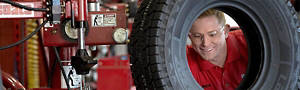 America's Tire Employee working on a tire/wheel assembly
