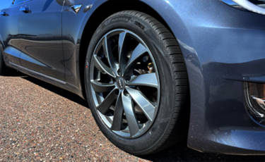 Bridgestone Turanza EV with ENLITEN rubber technology on a gray Tesla Model 3