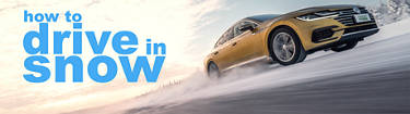 yellow sedan traveling quickly over a snowy highway with the words 'How to drive in snow' written on the left side.