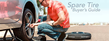 man changing a spare tire on his vehicle