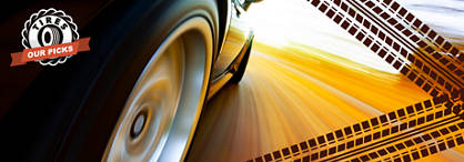 An image of a vehicle going fast with a zoom in on the back tire turning with a blurred background. Graphics of two tire tracks crosscross on the right and the words and tire insignia of 'Tires: Our Picks' is on the left