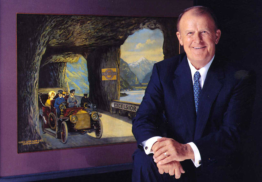Bruce Halle sitting in front of his artwork
