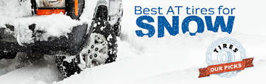 Truck driving through snow with all-terrain tires