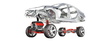 Aftermarket tire stacked next to a red sedan parked in a service bay