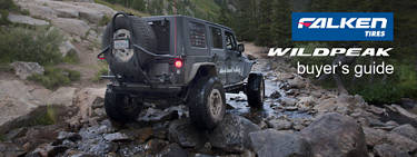 Jeep Wrangler with Falken Wildpeak AT tires crawling over rocks down a creek