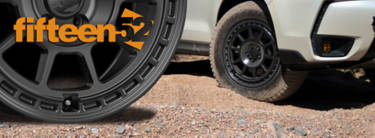 Fifteen52 Traverse MX wheel in gravel next to a white suv
