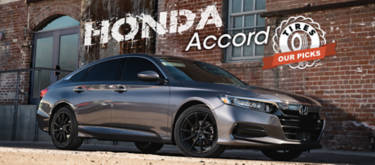 Grey Honda Accord parked next to a brick building