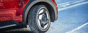 An image of a red SUV with a Michelin tire on it.