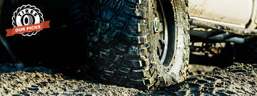An image of a truck with mud tires rolling through mud with the words 'Our Picks' on the top left.
