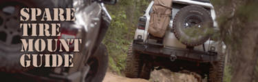 Two off-road vehicles with spare tires on the back crossing over a dirt road