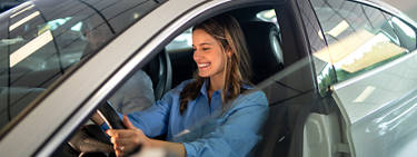 A woman waiting in her new car