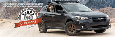 Grey Subaru Crosstrek soft-roading with husky dog in backseat.