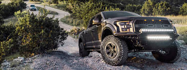 A ford f-150 with 35-inch tires climbing a hill in Texas.