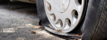 a flat tire with damage around the sidewall