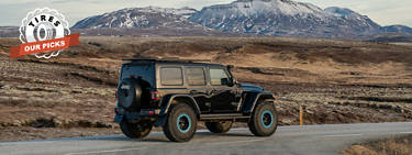 jeep wrangler 4xe traveling down a mountain road.
