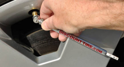 Using a standard tire pressure gauge to check tire air pressure