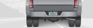 The rear end of a truck sporting dually wheels and a license place displaying DUALLY