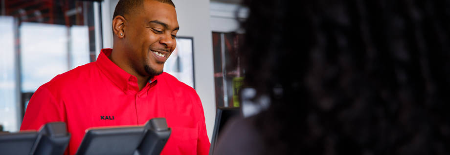 Discount Tire manager helping a customer redeem a certificate for tire replacement