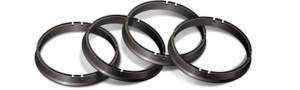 set of four black hub rings on a white background