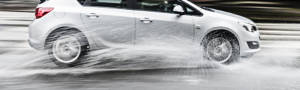 Silver crossover hydroplaning through water