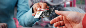 discount tire credit card handed to a person