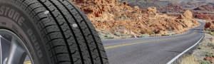 A punctured Bridgestone run flat tire on a open desert road
