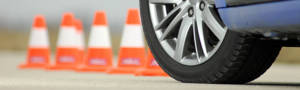 Blue car parked in front of traffic cones