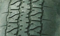 Underinflated tires (edge of tread worn)