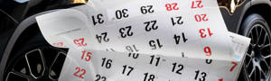 Black car with a calendar in front being flipped