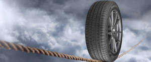 Pirelli tire balancing on a tight rope in the sky