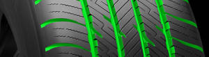 Tire with a green highlight over the tread groves