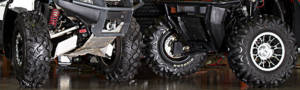 Two ATVs with new tires sitting side by side