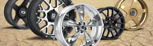 5 car and truck wheels in the desert with different finishes, sizes, and bolt patterns