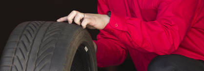technician inspecting a used tire