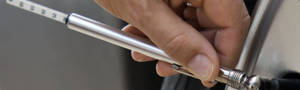 checking tire air pressure with an air guage