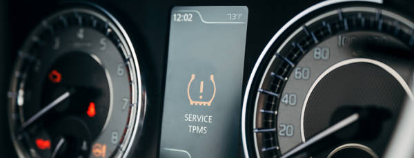Close up of dashboard with TPMS light illuminated