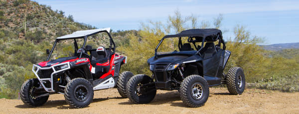 Two ATVs side-by-side sporting black and metallic aftermarket beadlock wheels, respectively.