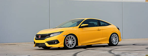 Yellow Honda sport coupe featuring aftermarket mesh wheels