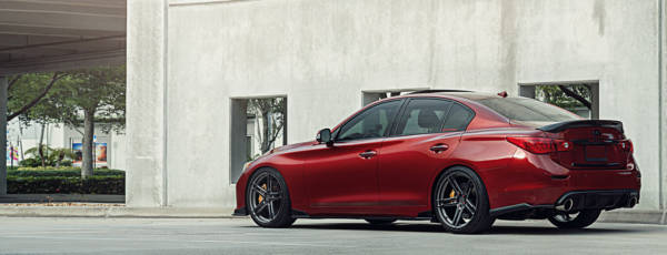Red sport sedan featuring aftermarket split-spoke rims