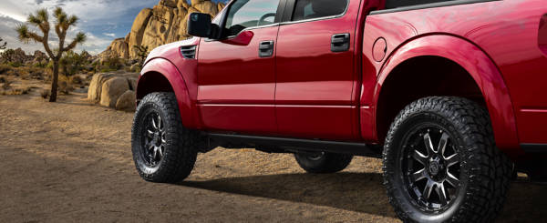 Red truck in the desert sporting 20x12 wheels