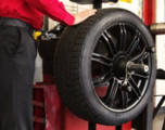 Technician applying road force balancing to a tire