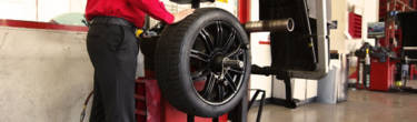 An America's Tire employee balancing a tire