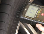 Technician resetting TPMS sensors in a tire