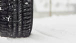 an image of a winter tire on a vehicle in snow