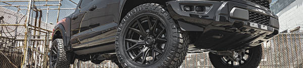 Large truck with large black wheels and off-road tires
