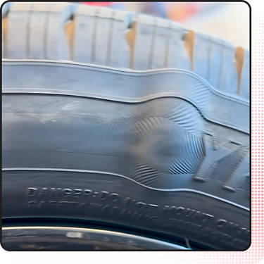 An image of a tire with an impact break or bubble in the sidewall
