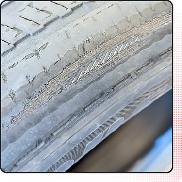 An image of a tire with exposed cords