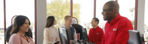 America's Tire customer and employee talking at the register area