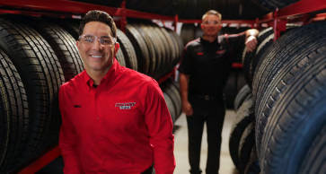 Two America's Tire employees among racks of tires