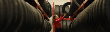 America's Tire employee storing a tire in the Tire Hotel